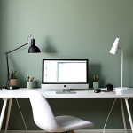 **Image Prompt 1: The Focused Sanctuary**
    A modern, minimalist home office bathed in soft, natural light. The walls are a calming, muted sage green, complemented by subtle accents of cool, muted blue in a desk lamp or a piece of decor. A person is seen deep in concentration at a sleek desk with a monitor, their posture relaxed and focused. The overall atmosphere conveys tranquility, deep concentration, and reduced stress.